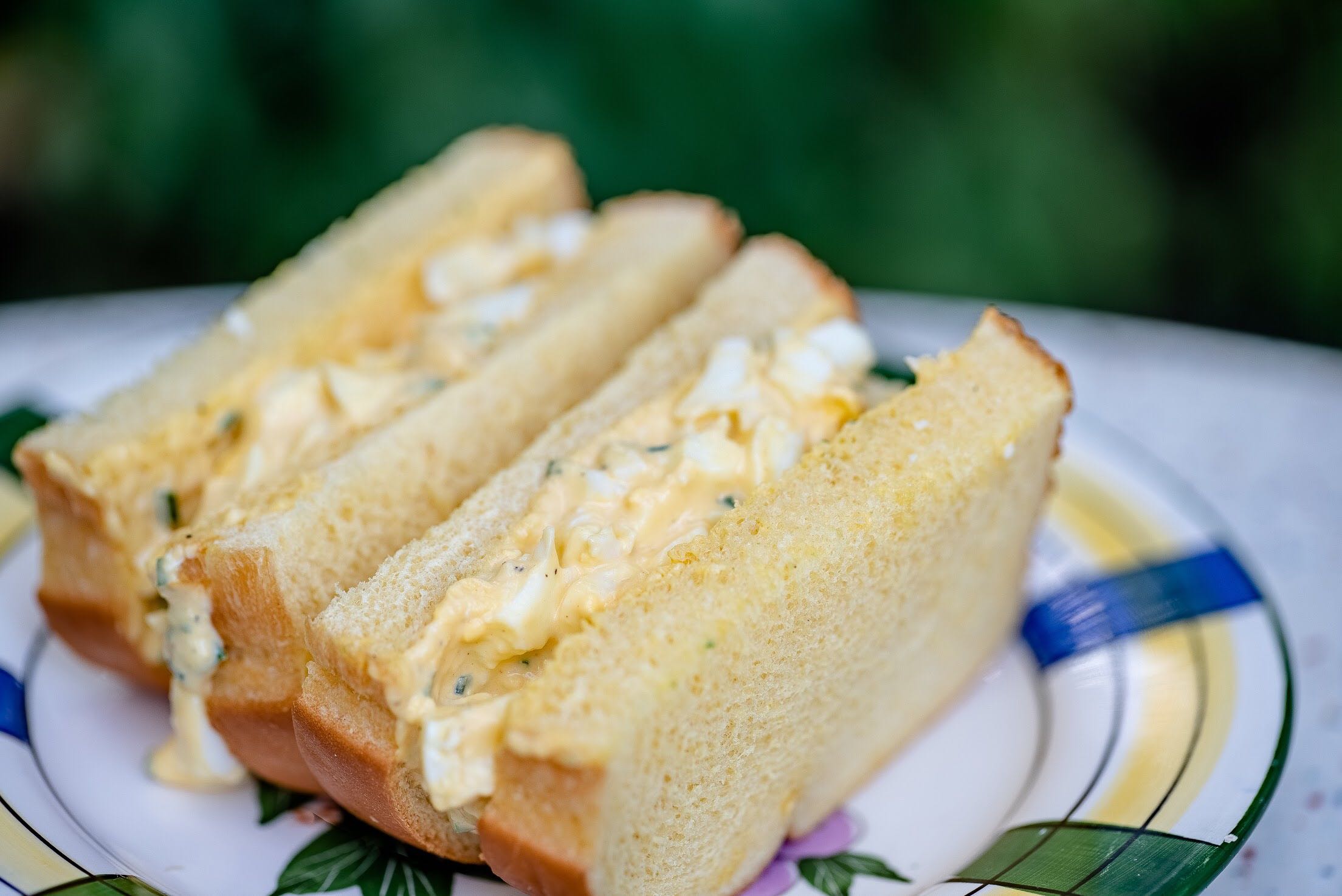 Egg salad sandwich on white bread. 