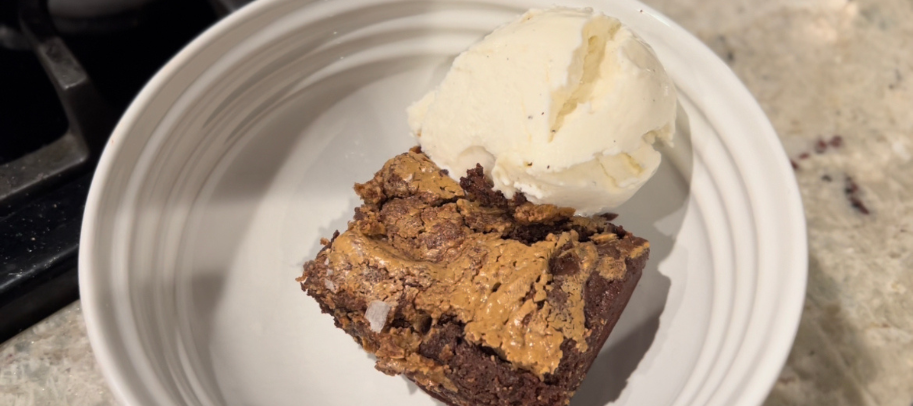 A brownie with a scoop of ice cream