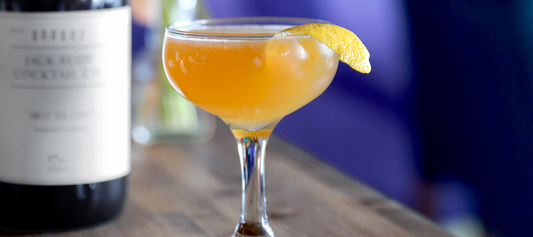 Jack Rudy's daytripper cockail next to a bottle of their syrup