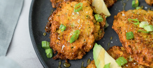 a plate of corn fritters with AR's hot honey
