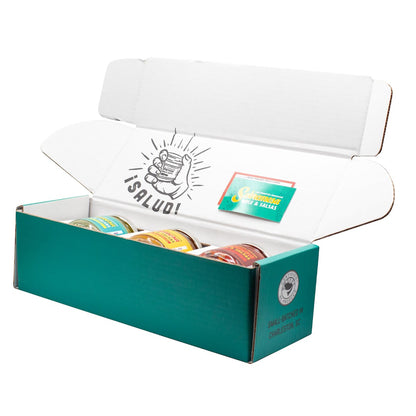 Open teal box with 'Salud' branding and colorful packages inside on a white background